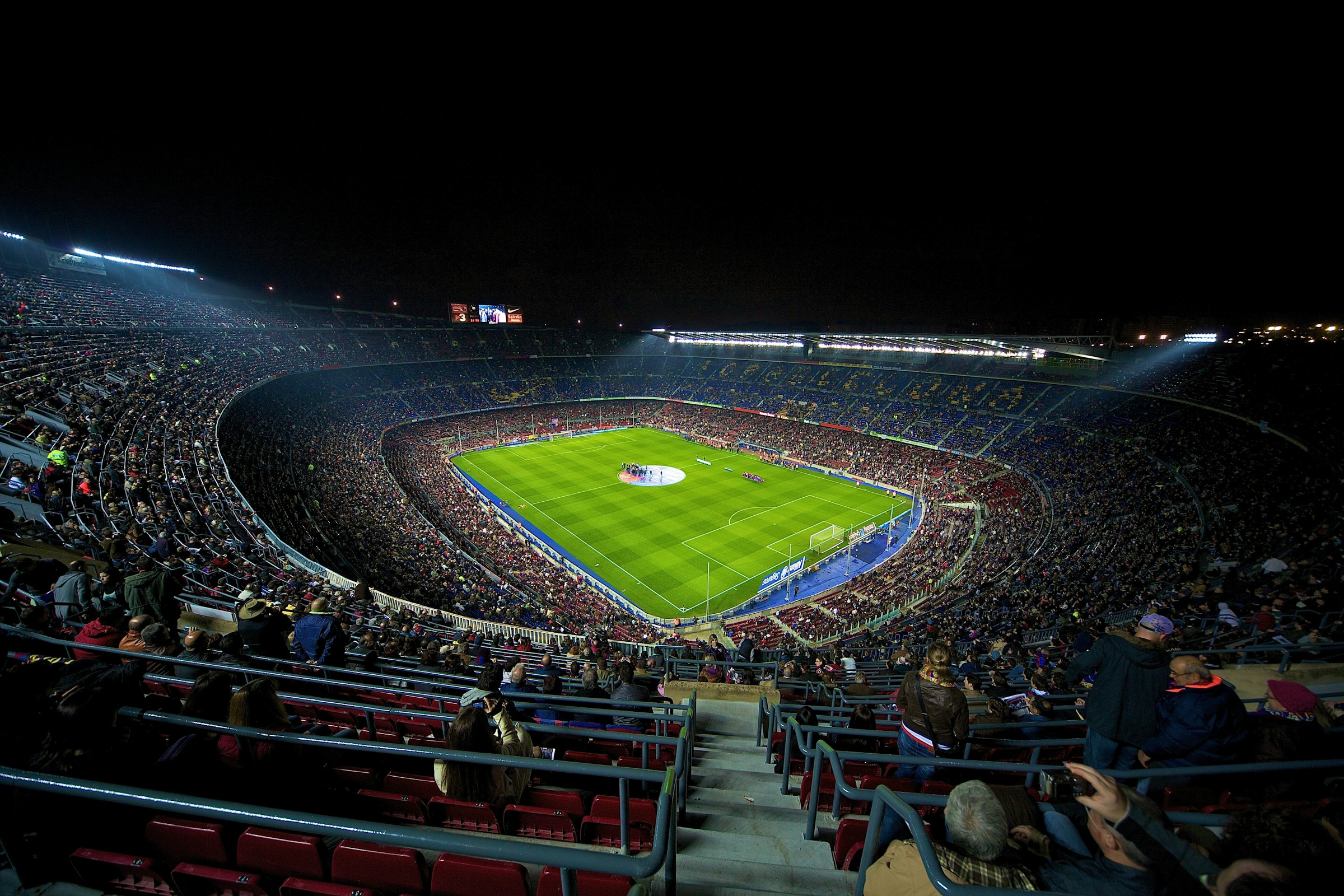 A football stadium illuminated during an evening event